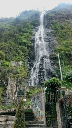 stairs leading up to a waterfall in the mountains