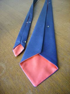 an orange and blue tie laying on top of a wooden table