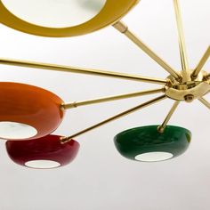 three different colored lights hanging from a ceiling