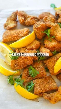 fried catfish nuggets with lemon wedges and parsley on the side