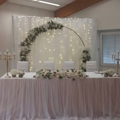 the table is set up with white flowers and candles