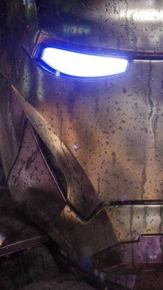 an iron man helmet with glowing eyes is seen in this close up shot from behind