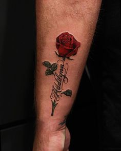 a man's arm with a rose tattoo on it and the word love written in cursive writing