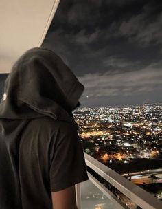 a person looking out over a city at night