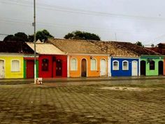 a row of colorful houses sitting on the side of a road