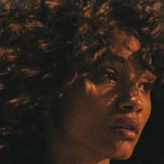 a close up of a woman with curly hair