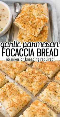 garlic parmesan focaccia bread cut into squares on a baking sheet