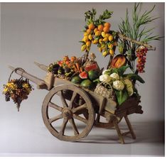 an old wooden wagon filled with lots of fruits and veggies on top of a white background