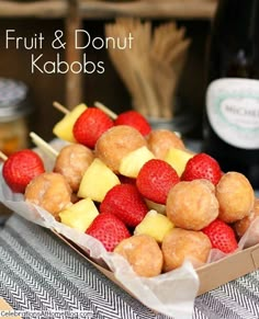 fruit and donut kabobs are sitting on a table