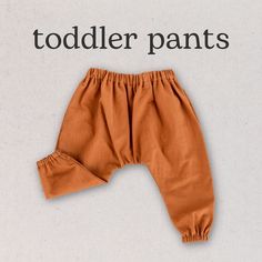 an orange pants with the words todder pants written in black and white above it