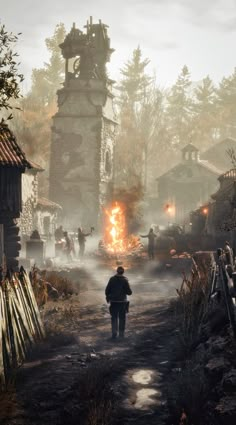 a man walking down a dirt road next to a forest