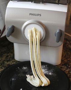 some noodles are being cooked in a frying pan