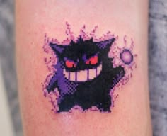 a pixelated image of a black cat with red eyes and fangs on it's arm