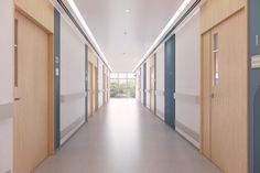 an empty hospital hallway with blue and white doors