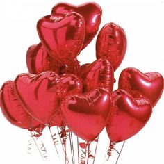 a bunch of red heart shaped balloons