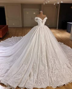 a white wedding dress on display in a room