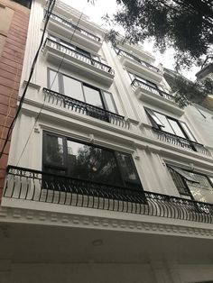 an apartment building with balconies and wrought iron railings on the front side