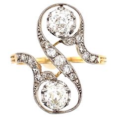 A stylish antique Edwardian platinum topped 18k gold double diamond ring, circa 1900. This interesting ring is sort of a play on a bypass style, though set more horizontally. It centers on two Old Mine cut diamonds weighing approximately 0.75 carats each. The two stones are graded as approximately H color and VS clarity. The diamonds are set in an "S” design with smaller single and old mine cut diamonds in the mounting. The ring is made in 18k yellow gold and the diamond section is topped with p Double Diamond Ring, Double Diamond, Double Ring, Edwardian Era, Rings Cool, Bridal Rings, French Antiques, Diamond Cuts, Diamond Ring