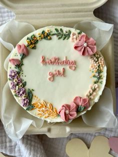 a birthday cake with flowers and the words happy birthday girl written on it in frosting