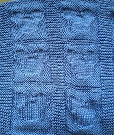 a blue knitted blanket sitting on top of a table