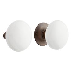 two light bathroom fixture with white glass globes on the front and back of it