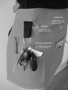 an apron with keys attached to it and some other things in the pocket around it