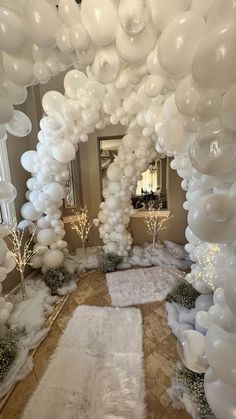 white balloons are hanging from the ceiling in an indoor area with carpeted flooring