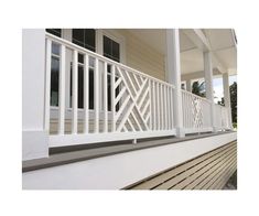 a porch with white railing and wood slats