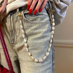 This Pearl jeans chain is the hot fashion accessories. The 19,5" lengths belt chain doubles as a bag chain that will add a touch of elegance to any outfit.  Key Features: - Can be used as a Perl belt chain, bag chain, necklace, mobile phone accessories or keychain - Pearls matches with any outfit - Perfect gift for moms or friends Made with high-quality faux pearl beads and gold plated materials, this Pearl jeans belt is durable and long-lasting. It's the perfect addition to your collection of f Chain On Jeans Outfit, Trendy Pearl Necklace With Chain For Parties, Trendy Pearl Chain Necklace For Party, Trendy Beaded Chain Pearl Necklace For Party, Trendy Beaded Pearl Necklace For Party, Trendy Pearl Necklace With Chain, Trendy Everyday Pearl Necklace, Trendy Gold Waist Chain For Gift, Trendy Gold Waist Chain As Gift