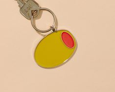 a keychain with a yellow and red oval design on it's side