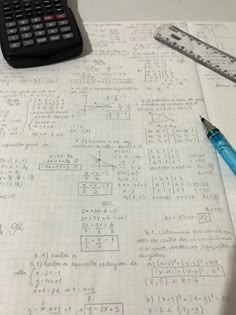 a calculator sitting on top of a piece of paper next to a ruler