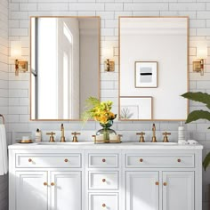 a white bathroom with two sinks and large mirrors on the wall next to each other