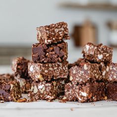 a pile of chocolate brownies sitting on top of a counter