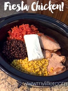 a crock pot filled with meat, beans and corn