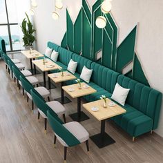 an empty restaurant with green booths and wooden tables