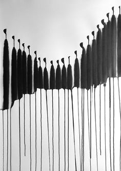 black and white photograph of many long sticks sticking out of the side of a wall