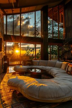 a living room filled with lots of furniture next to a large window covered in windows