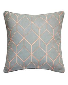 a blue and pink pillow with an orange geometric design on the front, sitting on a white background