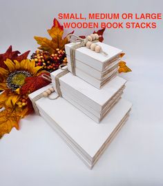 small, medium or large wooden book stacks with fall leaves and sunflowers in the background