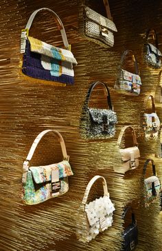 Fendi Baguette Wall details at the Flagship store in Paris: on the ground floor this installation surrounding the Iconic Fendi bag. Thirty thousand needles of bronze pierce the wall to display the different styles surronded by a halo of light.