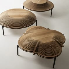 three wooden tables sitting on top of each other