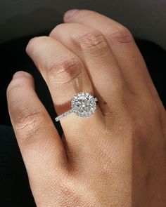 a woman's hand with a diamond ring on it