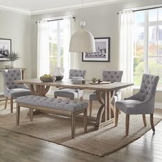 a dining room table with chairs and a bench