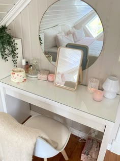 a white desk with a mirror on top of it and a chair in front of it