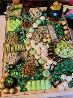 a table filled with lots of green and white treats