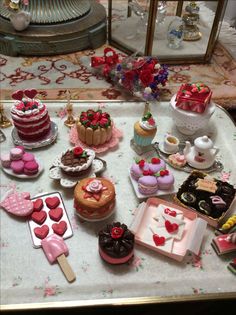 a table topped with lots of cakes and desserts