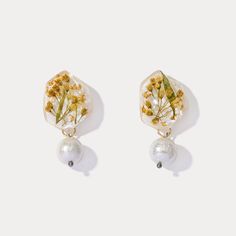 Elevate your style with our Czech Crystal Flower Earrings! These sparkling earrings feature adorable tiny yellow flowers sealed in resin, adding a unique touch to your outfit. The glitter and shining crystals give off a refreshing pastoral vibe, perfect for summer. Stand out with our eye-catching design and embrace the beauty of nature. DETAILS Materials: 18k Gold on Brass, Czech Crystal, Resin Size: 1.45 ''*0.79''(3.7 cm*2cm) Weight: 3.6g Czech Crystal, Crystal Flower, Pearl Drop, Pearl Drop Earrings, Real Flowers, Flower Earrings, Yellow Flowers, Dried Flowers, Women's Earrings