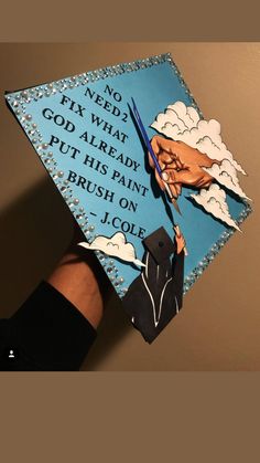 a hand holding a graduation cap that says no need to fix what god already put his paint brush on