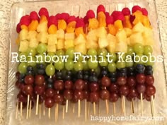 fruit skewers are arranged in rainbow colors