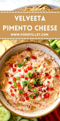 velveeta pimentoo cheese dip in a bowl surrounded by sliced cucumbers